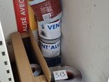 a stack of boxes and a roll of tape next to each other