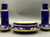 trois vases bleus et un bol posés sur une table