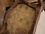 a chair that has a seat made of wood and a seat made of fabric