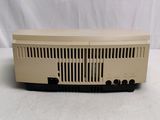 an image of a tan radio sitting on top of a white table