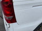 a white van that is parked on the side of the street