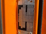 a close up of a metal plate on the side of an orange truck