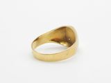 a close up of a gold ring on a white surface