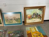 many paintings on the floor next to each other