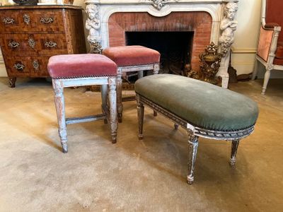 two stools that are sitting in front of a fire place