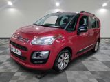 the red citrole is parked in a large room