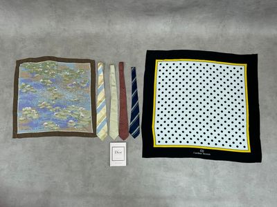 two ties, a handkerchief, and a pocket square are laid out on a table