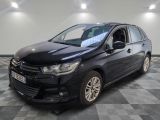 la voiture noire est garée sur un sol en damier dans le garage