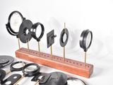 a lot of clocks that are on a wooden stand