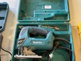 an image of a tool box with a cord saw and other tools
