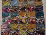 a close up of a pile of pokemon cards on a bed