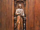 une image représentant une sculpture sur bois d'un homme assis sur une chaise
