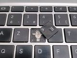 a small flash drive sitting on top of a laptop keyboard