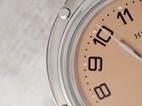 a close up of a watch on a white surface
