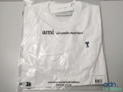 an image of a white t - shirt on a hanger on a wall