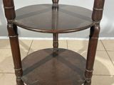 an image of a three tiered table on a tile floor