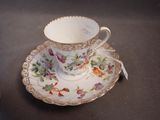 a cup and saucer sitting on a table