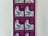 a stamp with a picture of a man sitting on a bench