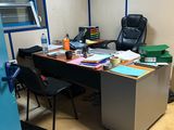 a desk with a chair and a computer on it in a room