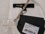 a white dress with a gold chain on it
