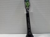 a black toothbrush with green and white toothpaste on it