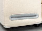 a close up of a couch with a remote control on it