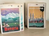 two books on a table with a picture of a city in the background