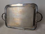 a silver tray with handles sitting on a table