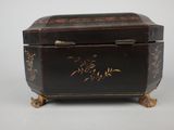 a small black box with gold designs on it