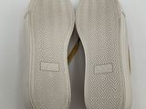 the soles of a pair of white shoes on a white surface