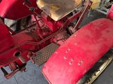 a red motorcycle that is parked in a garage