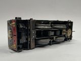 a close up of a toy train engine on a white surface