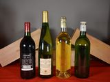 several bottles of wine are lined up on a table