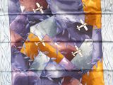 purple, orange, and yellow silk scarf with airplanes on it