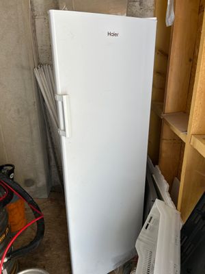 a white refrigerator that is in a room with a lot of stuff