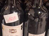 several bottles of wine are lined up on a shelf in a store