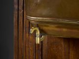 a close up of a door handle on a wooden cabinet