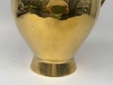 a gold vase that is sitting on a table