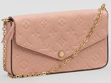 un sac-portefeuille rose Louis Vu Vu avec une bandoulière à chaîne