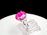 a pink ring sitting on top of a white table