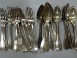 a lot of silver spoons and spoons on the table