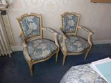two chairs sitting next to each other in a room
