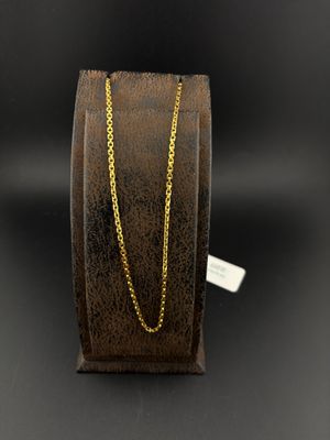 a close up of a gold chain on a black background