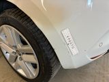 a close up of a white car with a sticker on it