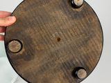 a person holding a wooden plate with holes in it