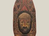 sculpture of a man ' s face on a stand with a geometric pattern