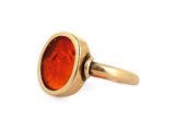 an image of a gold ring with a red stone in the center