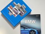two books on a white table with a blue box on top of it