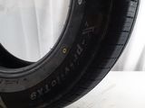the tire of a car is sitting on a white surface