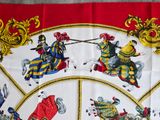 a picture of a table cloth with a picture of knights on horseback